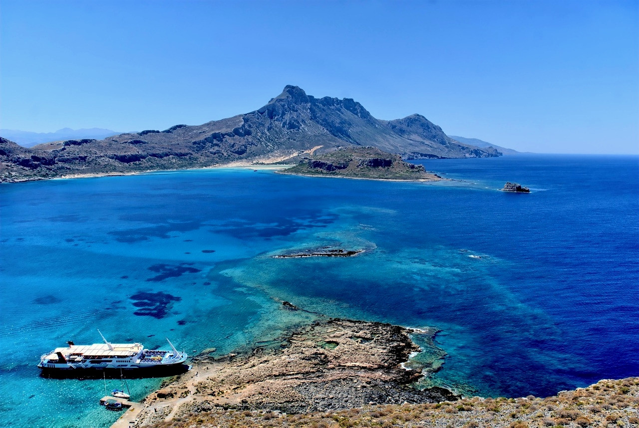 Islet and turquoise waters of the Aegean Sea - Greece