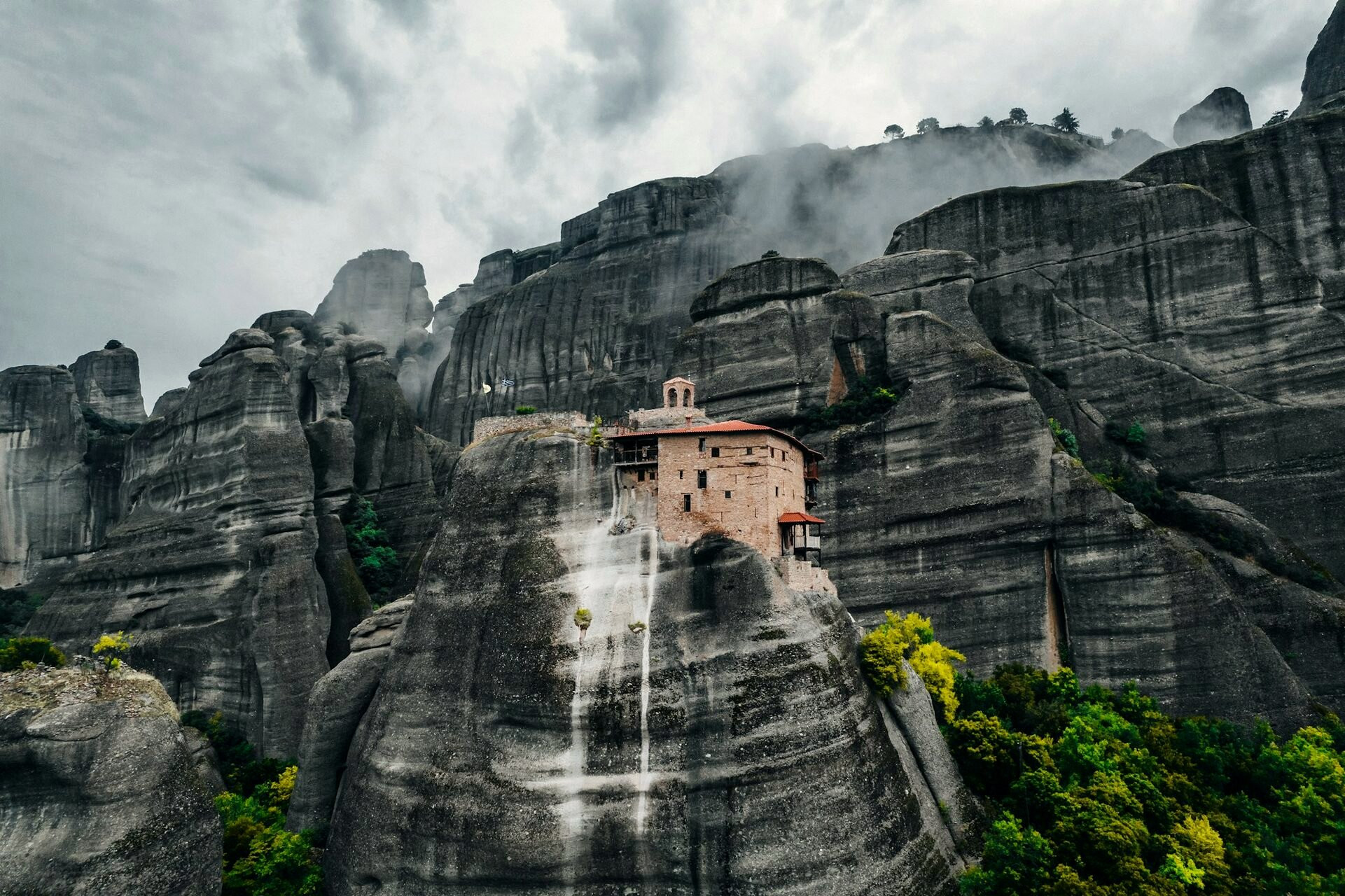 Meteora monastery perched on its sandstone pinnacle at sunset - Thessaly, Greece