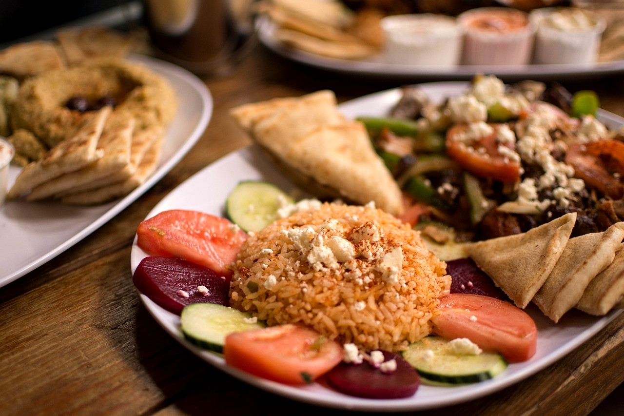 Table of Greek mezze, bread and salads in a taverna - Greece