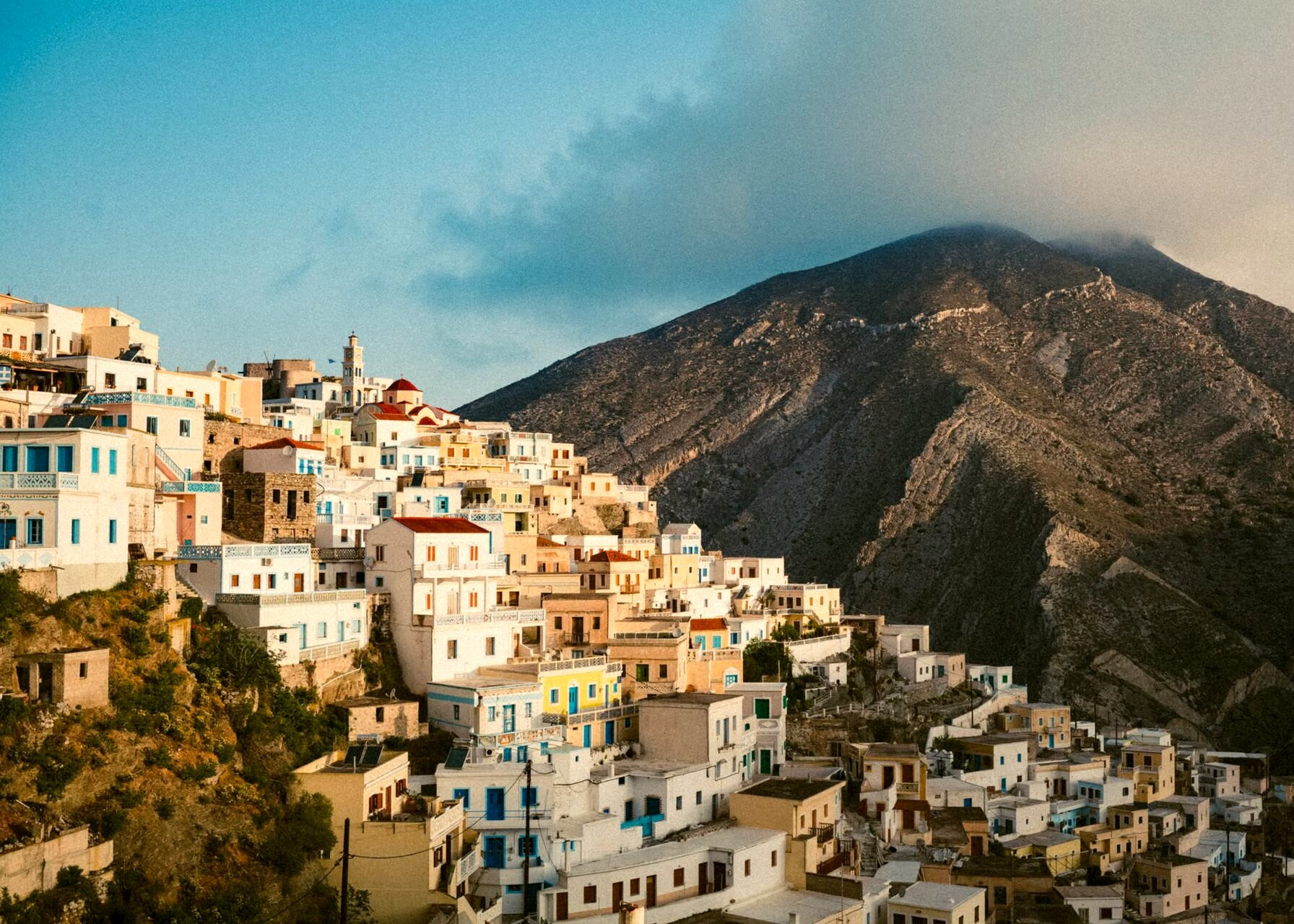 The perched village of Olympos and its colourful houses tiered along the ridge - Karpathos, Greece