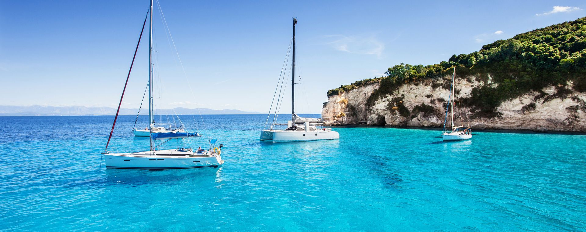 Sailboats at anchor in a bay on Paxos - Ionian Islands - Greece