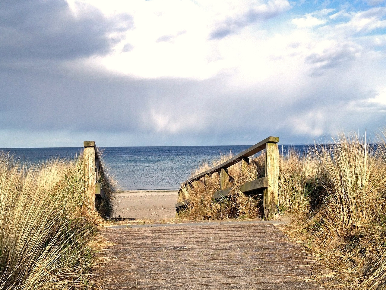 Wooden path leading to the beach through the dunes - Greece